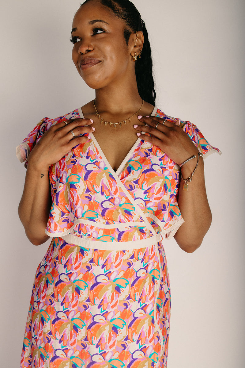 The Longoria Scalloped Hem Wrap Dress in Peach Floral Medium The Longoria Scalloped Hem Wrap Dress in Peach Floral Medium