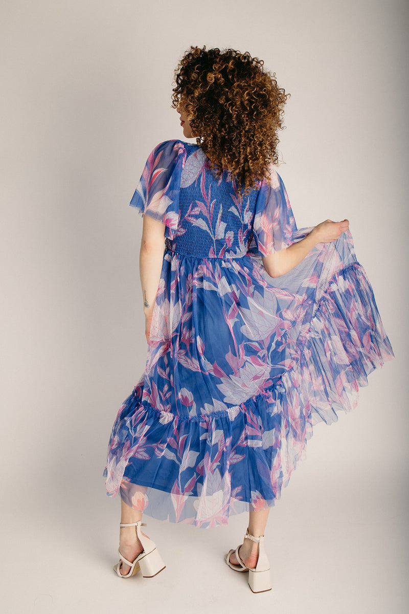 The Vela Smocked Detail Midi Dress in Blue Floral Piper & Scoot The Vela Smocked Detail Midi Dress in Blue Floral Piper & Scoot