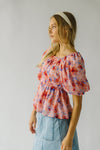 The Kinsella Floral Peplum Blouse in Peach Multi