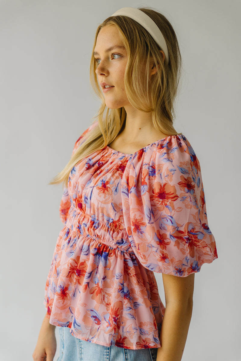 The Kinsella Floral Peplum Blouse in Peach Multi