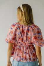 The Kinsella Floral Peplum Blouse in Peach Multi