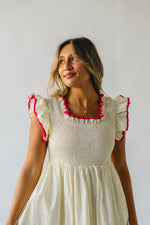 The Midgely Smocked Ruffle Detail Dress in Cream + Red