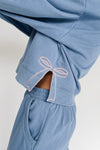 The Monzingo Bow Embroidered Pullover in Dusty Blue