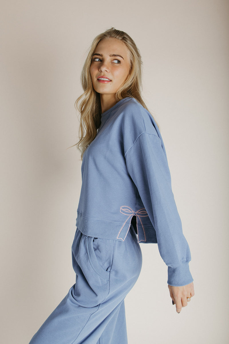 The Monzingo Bow Embroidered Pullover in Dusty Blue
