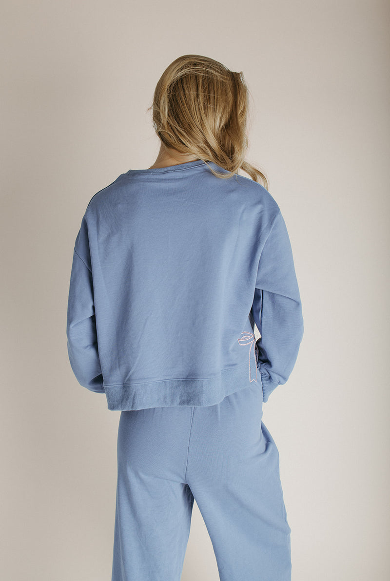 The Monzingo Bow Embroidered Pullover in Dusty Blue