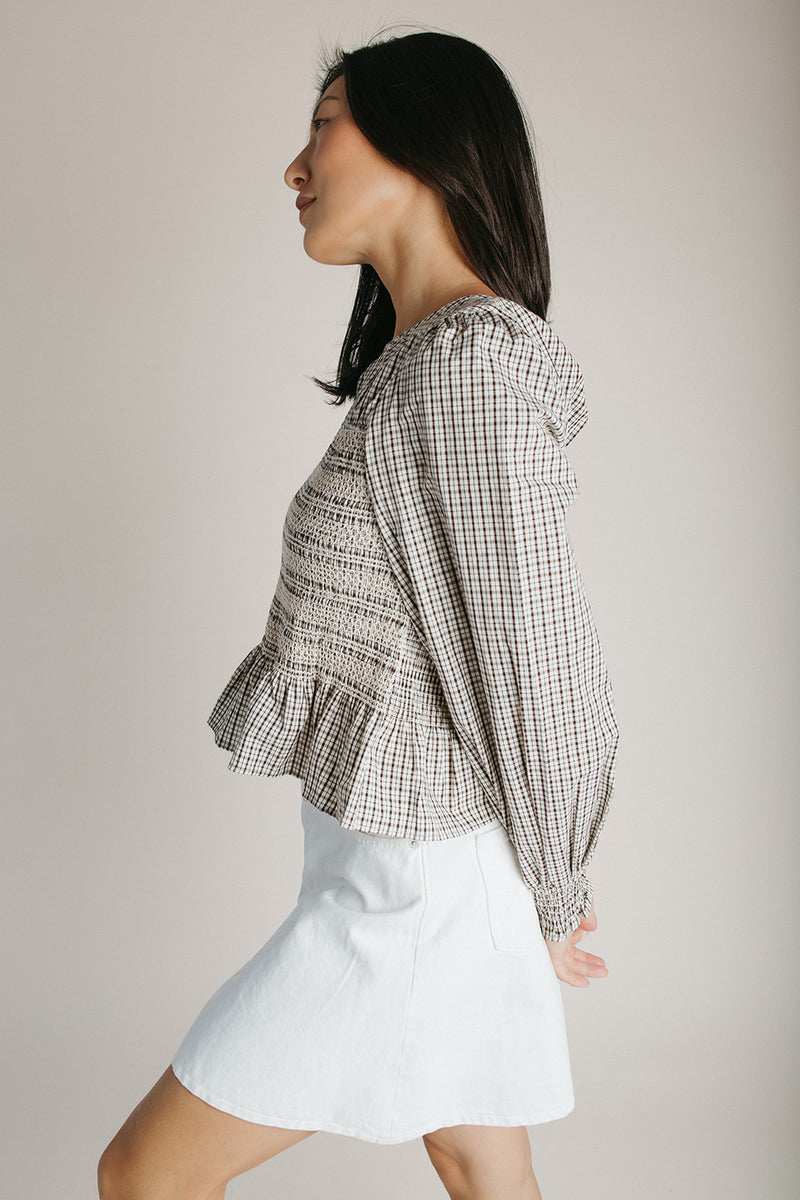 The Delgra Smocked Peplum Blouse in Cream + Brown