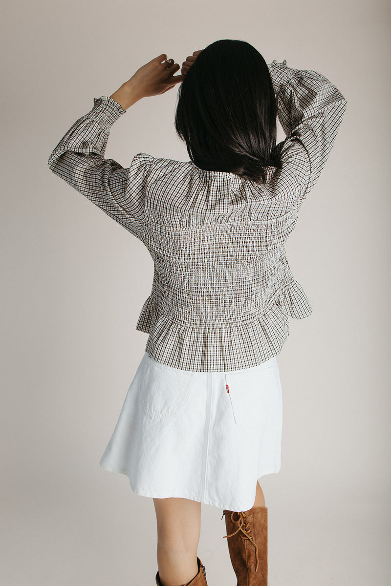 The Delgra Smocked Peplum Blouse in Cream + Brown