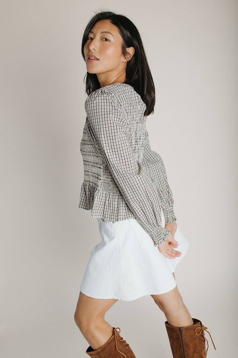 The Delgra Smocked Peplum Blouse in Cream + Brown
