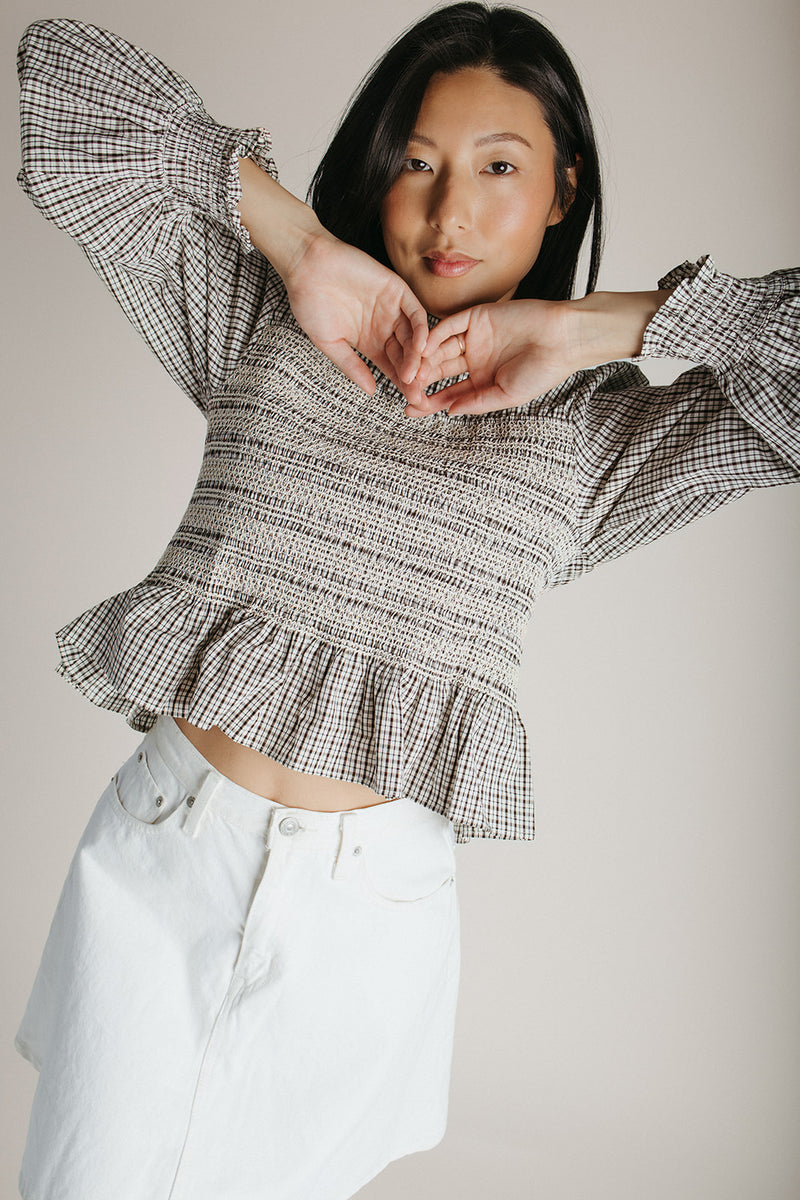 The Delgra Smocked Peplum Blouse in Cream + Brown