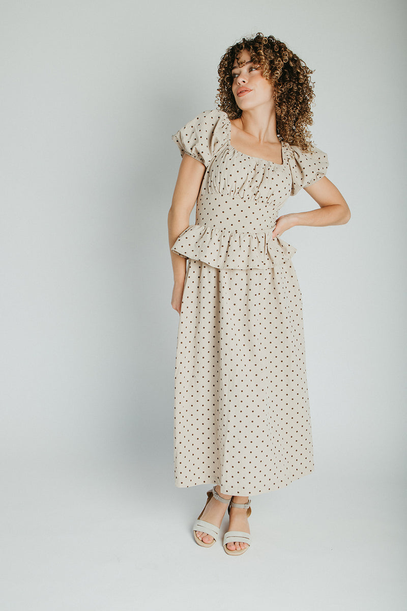 The Stacy Polka Dot Peplum Midi Dress in Taupe + Brown