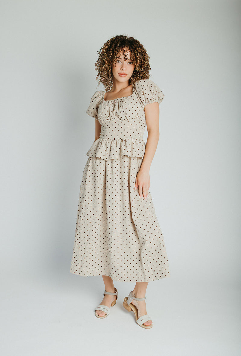 The Stacy Polka Dot Peplum Midi Dress in Taupe + Brown