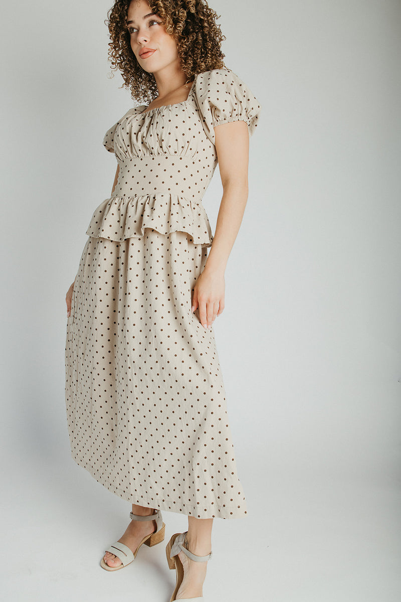 The Stacy Polka Dot Peplum Midi Dress in Taupe + Brown