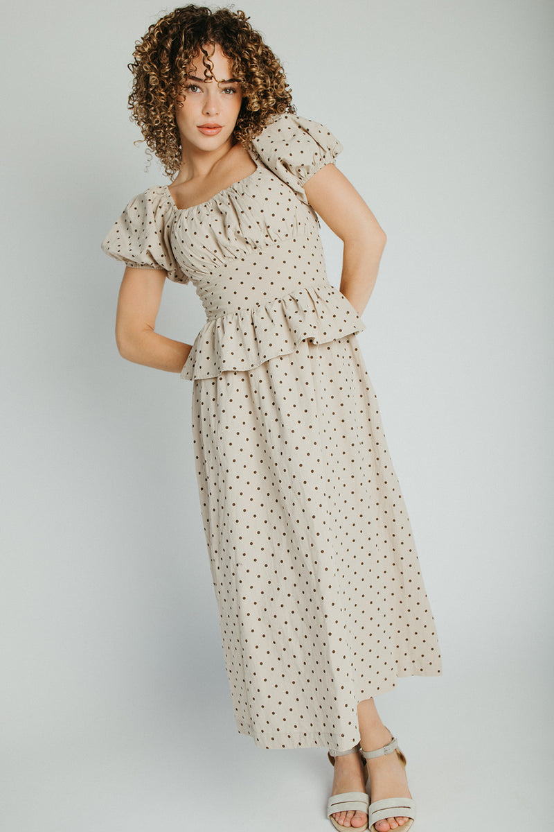 The Stacy Polka Dot Peplum Midi Dress in Taupe + Brown