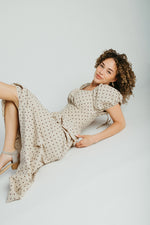 The Stacy Polka Dot Peplum Midi Dress in Taupe + Brown