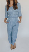 The Quintana Smocked Floral Jumpsuit in Denim