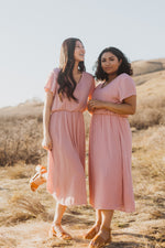 The Derby Dress in Blush, lifestyle shoot; front view paired with friend