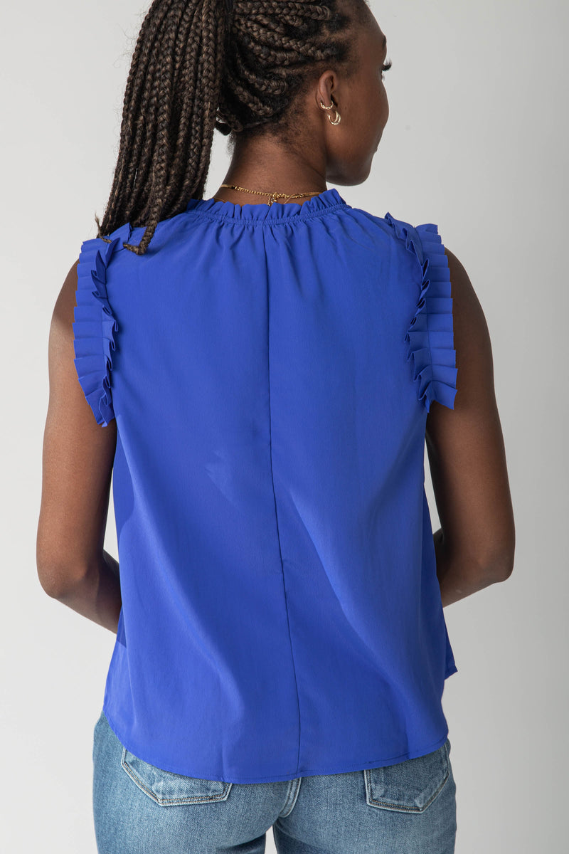 The Wilmer Ruffle Sleeve Top in Royal Blue, studio shoot; back view
