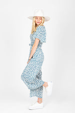 The Alicia Square Neck Jumpsuit in Blue Floral, studio shoot; side view