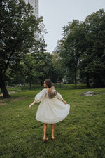 Piper & Scoot: The Adanna Floral Detail Dress in Cream, lifestyle shoot; back view